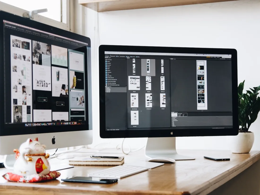 An iMac and a second display on a timber desk
