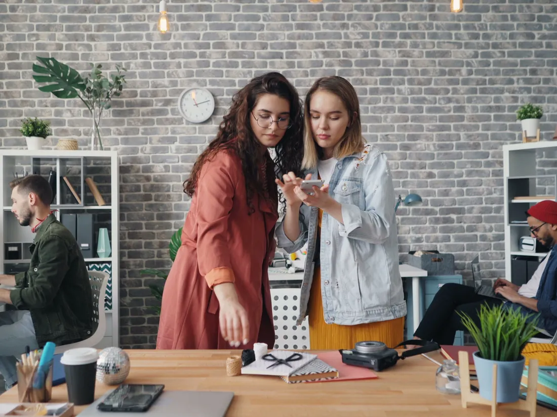Colleagues talking in a small office